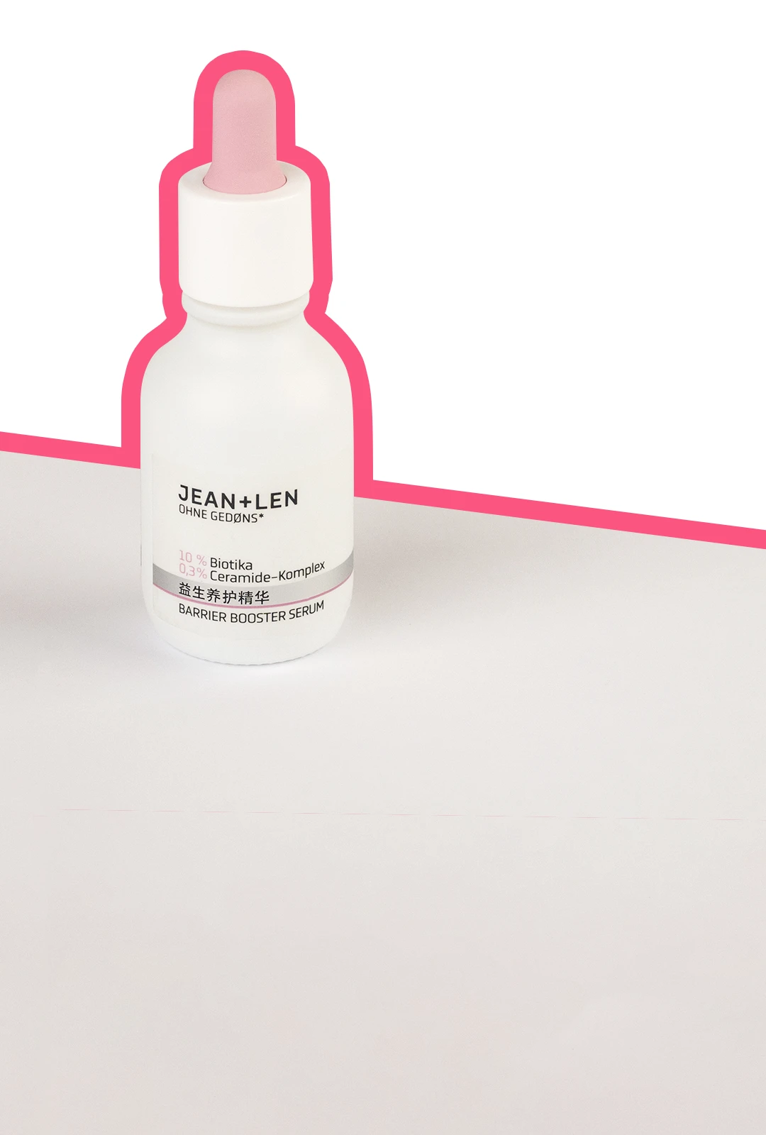 Barrier Booster Serum auf einem grauen Tisch umrandet von einer knallpinken Linie.